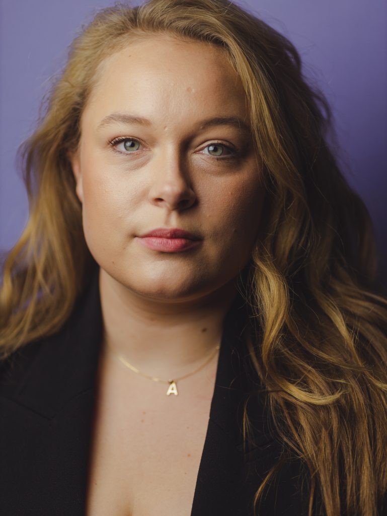 A photo of Annabel from the shoulders up, her hair is loose around her shoulders