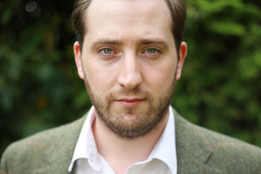 A photo of Michael from the shoulders up, wearing a green jacket